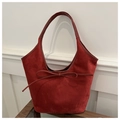Detail of red matte tote bag featuring soft suede texture and decorative ribbon bow - Red
