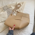 Minimalist beige woven leather tote bag with large weave texture and slim shoulder straps - Khaki