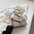 Minimalist taupe crossbody square bag with gold horsebit hardware on white blazer - Khaki
