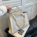 White floral lace tote bag with pearl chain detail and elegant faux leather handles - White