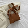 Brown leather square handbag with wide shoulder strap and mini coin purse on white blazer - Brown
