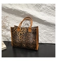 Fashionable leopard print large tote bag with brown handles on a modern background - Brown