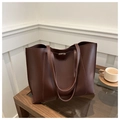 Detail of dark brown tote bag with metal buckle closure and long shoulder straps - Brown