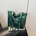 Deep green quilted puffer tote bag with glossy metallic finish and front snap pocket - Green