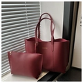 Detail of burgundy leather tote bag set showing the fine texture and gold fashion logo - Red