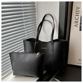 Detail of black faux leather tote bag and matching pouch with gold lettering - Black