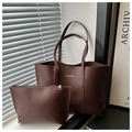 Detail of dark brown tote bag set with golden logo text and matching small pouch - Coffee