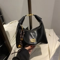 Black glossy leather crescent hobo bag with gold metal logo and braided charm - With Pendant / Black