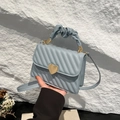 Quilted light blue handbag featuring golden heart clasp and stylish ruched handle design - Blue