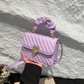 Elegant lavender pleated handbag with golden heart clasp and stylish scrunchie handle - Purple