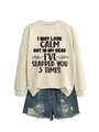 Close-up of cream crewneck sweatshirt with black slogan and frayed denim shorts - Sand (Black Print)