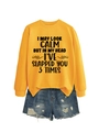 Detail of yellow crewneck sweatshirt with humorous slogan print and distressed denim shorts - Yellow (Black Print)