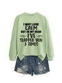 Detailed flat lay of green slogan sweatshirt and ripped denim shorts set with fringe trim - Olive Green (Black Print)