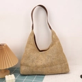 Bohemian woven straw tote bag with brown shoulder straps in a minimalist home setting - Brown