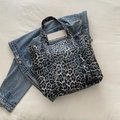 Canvas tote bag featuring grey-blue leopard print with a front pocket and wide handles - Black