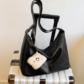 Minimalist large black leather tote bag with a cute plush monster charm on a white suitcase - With Pendant / Black