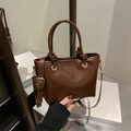 Bolso tipo cubo vintage marrón con asas redondas y letras de moda grabadas - Marrón