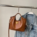 Detailaufnahme der braunen Retro-PU-Ledertasche mit goldenem Dreieckslogo am Ständer - Mit Anhänger / Braun