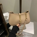 Chic beige matte leather underarm bag featuring a stylish gold metallic bar closure - Khaki