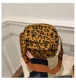 Detail of leopard print corduroy crossbody bag featuring front pocket and woven strap - Brown
