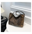 Makro-Detail der Leopard-Print Shopper-Tasche auf einem minimalistischen weißen Sockel - Braun
