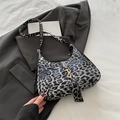 Leopard print crescent hobo bag with gold buckle in black and white faux fur texture - Black