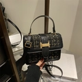 Quilted tweed crossbody bag in black and gold with a metallic clasp and leather strap - Black