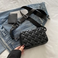 Black quilted crossbody bag with wide strap and matching mini pouch on denim background - Black