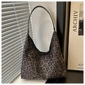 Detail of grey leopard print shoulder bag featuring premium texture and leather strap - Coffee