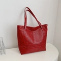 Large red crocodile pattern tote bag with shoulder straps on a white podium - Burgundy