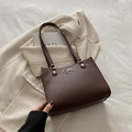 Brown vintage faux leather tote bag featuring a silver bow decoration and dual shoulder straps - Brown