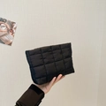 Chic black quilted puffer clutch bag with modern square pattern and lightweight design - Black