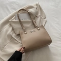 Elegant beige tote bag with silver metal bow detail and matching long shoulder strap - Khaki