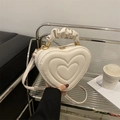 Chic cream heart-shaped crossbody bag with quilted circles and a ruched cloud handle - White