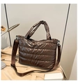 Close-up of coffee brown quilted tote bag showing padded texture and nylon strap - Brown