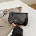 Minimalist black patent leather crossbody bag with silver logo and metal chain strap - Black