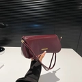 Chic burgundy patent leather underarm bag with Fashion & Bags lettering on flap - Red Brown