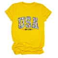 Close-up of bright yellow T-shirt featuring floral USA letters and EST. 1776 print - Yellow