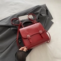 Glossy red patent leather backpack with dual silver buckle straps and top handle - Red