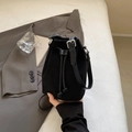 Minimalist black suede bucket bag with drawstring closure and silver hardware details - Black
