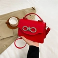 Elegant red fashion handbag featuring a sparkling rhinestone bow buckle and top handle - Red