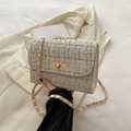 Cream tweed flap crossbody bag with gold chain strap and rectangular turn-lock closure - White