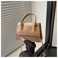 Detailed macro view of camel PU leather handbag texture with top handle and strap - Rose Pink