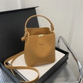 Fashionable tan brown faux leather bucket bag with top handle and FASHION embossed detail - Brown