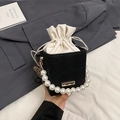 Contrast black woven crossbody bag with white drawstring pouch and large pearl handle - Black