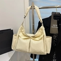 Minimalist beige canvas tote bag with large cargo pockets and adjustable shoulder strap - Off White