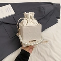 Chic cream woven bucket bag with large pearl handle and gold chain shoulder strap - White