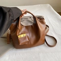 Brown leather bucket bag with top handles, crossbody strap, and mini charm accessory - Vertical Stitching Style / Brown