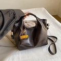 Dark brown leather bucket bag with top handles and a bright yellow mini bag charm - Yellow Charm Style / Brown