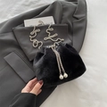 Black faux fur bucket bag featuring a silver chain strap and decorative pearl drawstrings - Black
